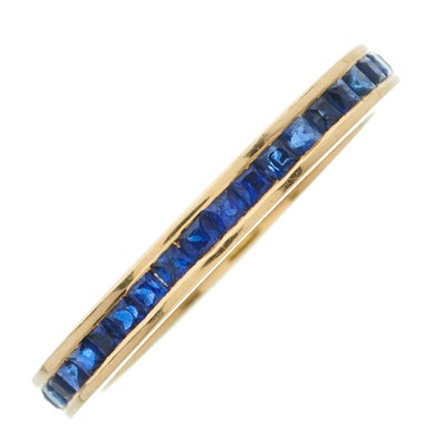 Lot 54 - An 18ct gold calibre-cut sapphire full...