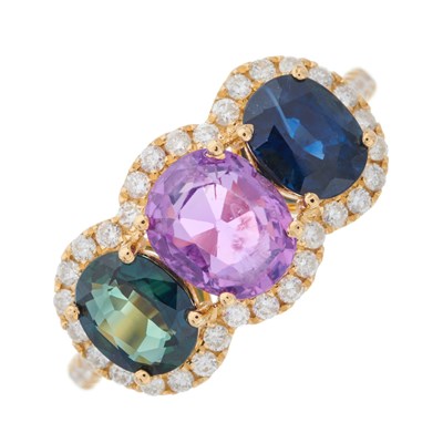 Lot 64 - An 18ct gold vari-hue sapphire three-stone...