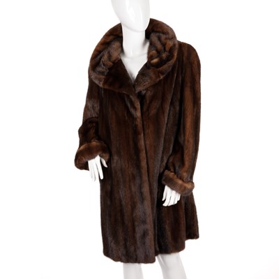 Lot 486 - A knee-length chestnut mink coat, featuring a...