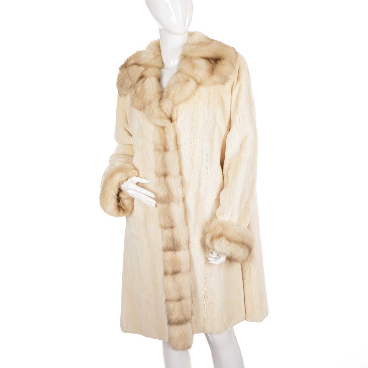 Lot 490 - A sheared mink and golden sable trimmed coat,