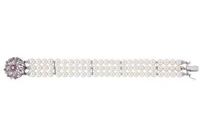 Lot 174 - A cultured pearl three-row bracelet, with 18ct gold ruby and diamond clasp