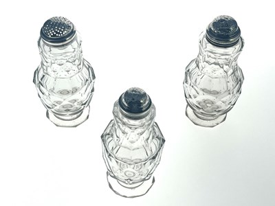 Lot 77 - Three silver mounted facet cut glass condiment shakers