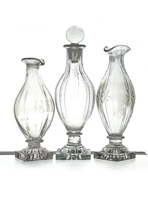 Lot 465 - Three George III glass condiment bottles