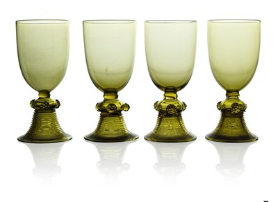 Lot 579 - A set of four Arts and Crafts green glass...