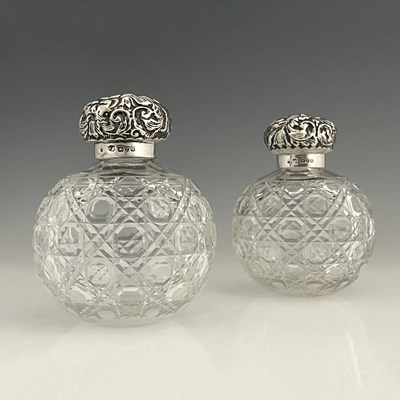 Lot 196 - Two Victorian silver mounted perfume bottles,...
