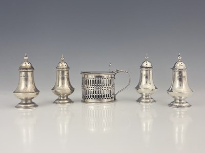 Lot 200 - A set of four George V silver pepperettes, of...