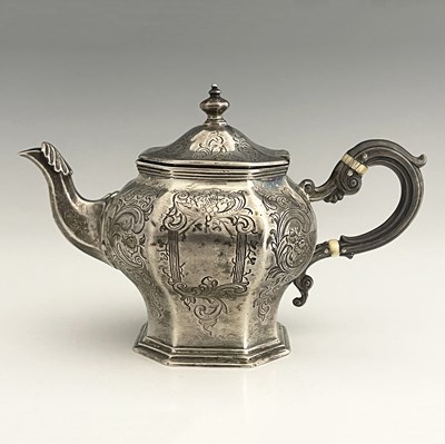 Lot 230 - A Victorian Chinoiserie style silver teapot,...