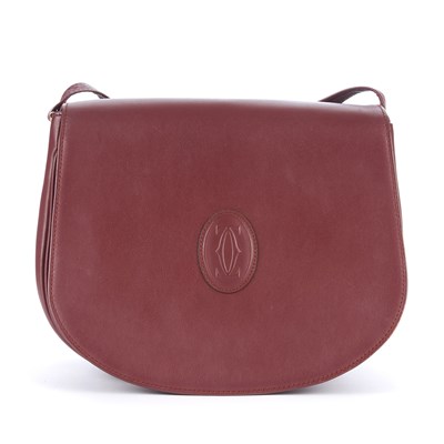 Lot 25 - Cartier, a Must De Cartier Bordeaux crossbody...