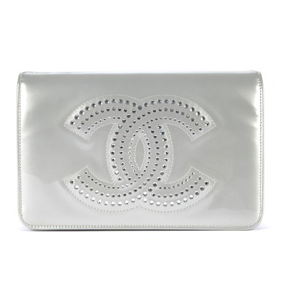 Lot 58 - Chanel, a silver patent leather Strass Wallet...