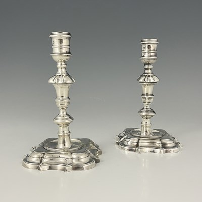 Lot 288 - A pair of George II silver cast candlesticks,...