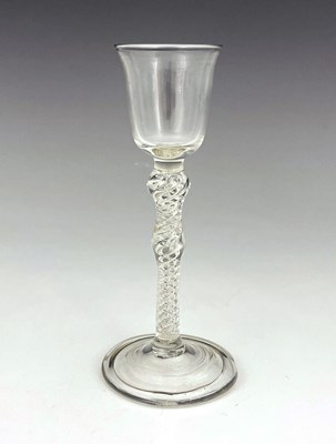 Lot 519 - A double knopped air twist wine glass, the...