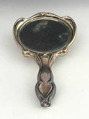 Lot 112 - An American Art Nouveau silver hand mirror,...