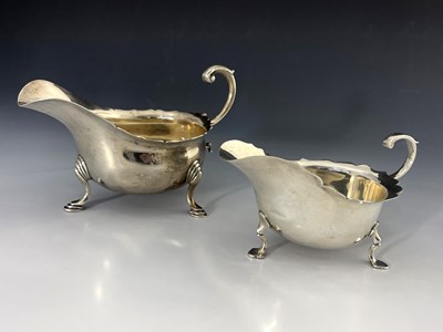 Lot 55 - An Edwardian and George V silver sauce boat,...