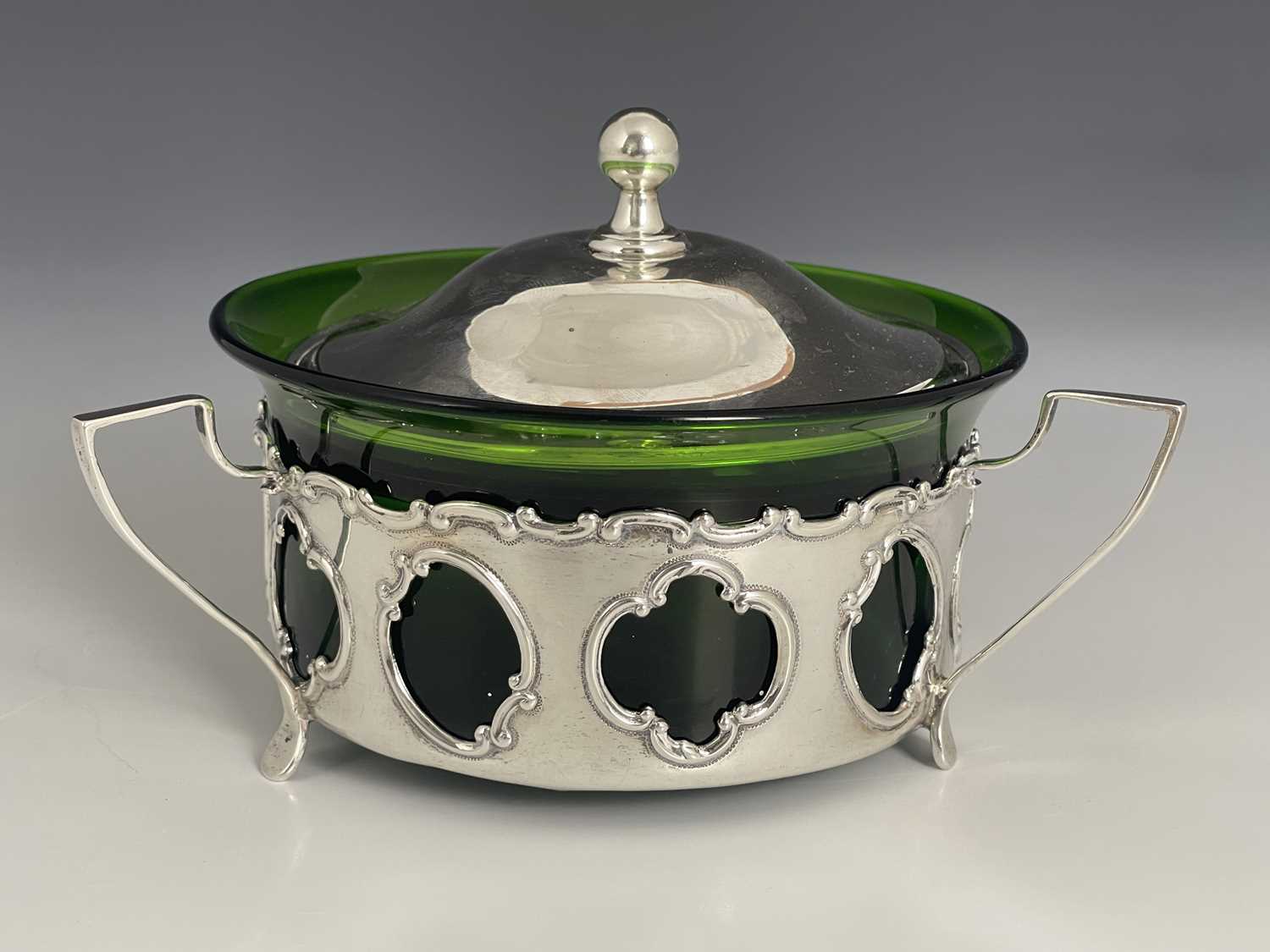 Lot 121 - An Arts and Crafts silver and green glass dish...