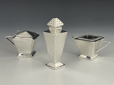 Lot 143 - An Art Deco style silver three piece cruet,...