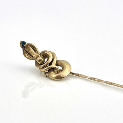 Lot 10 - A 9ct gold stick or tie pin with coiled cobra...