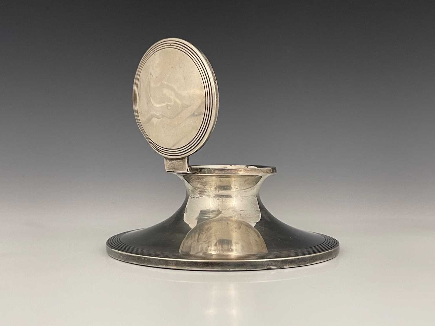 Lot 10 - A George V silver capstan inkwell, the base...