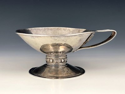 Lot 67 - An Arts and Crafts single handled cup, in the...