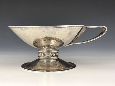 Lot 67 - An Arts and Crafts single handled cup, in the...