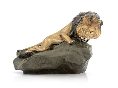 Lot 785 - A Royal Doulton figure of a lion on a rock,...