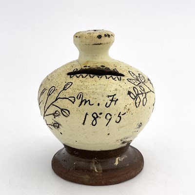 Lot 865 - A slip-decorated money box, dated 1895 with...