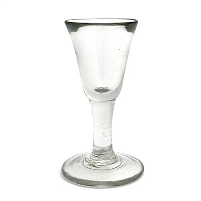 Lot 524 - A plain stemmed toasting glass, circa 1740,...