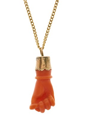 Lot 48 - A late 19th century gold, coral figa pendant,...