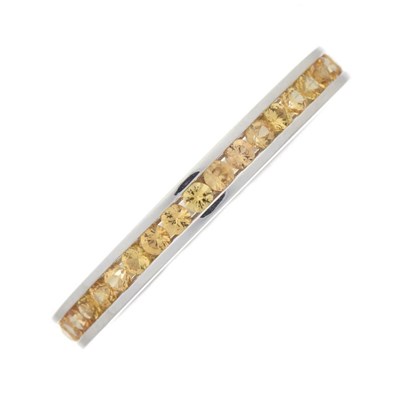 Lot 140 - An 18ct gold yellow sapphire full eternity...