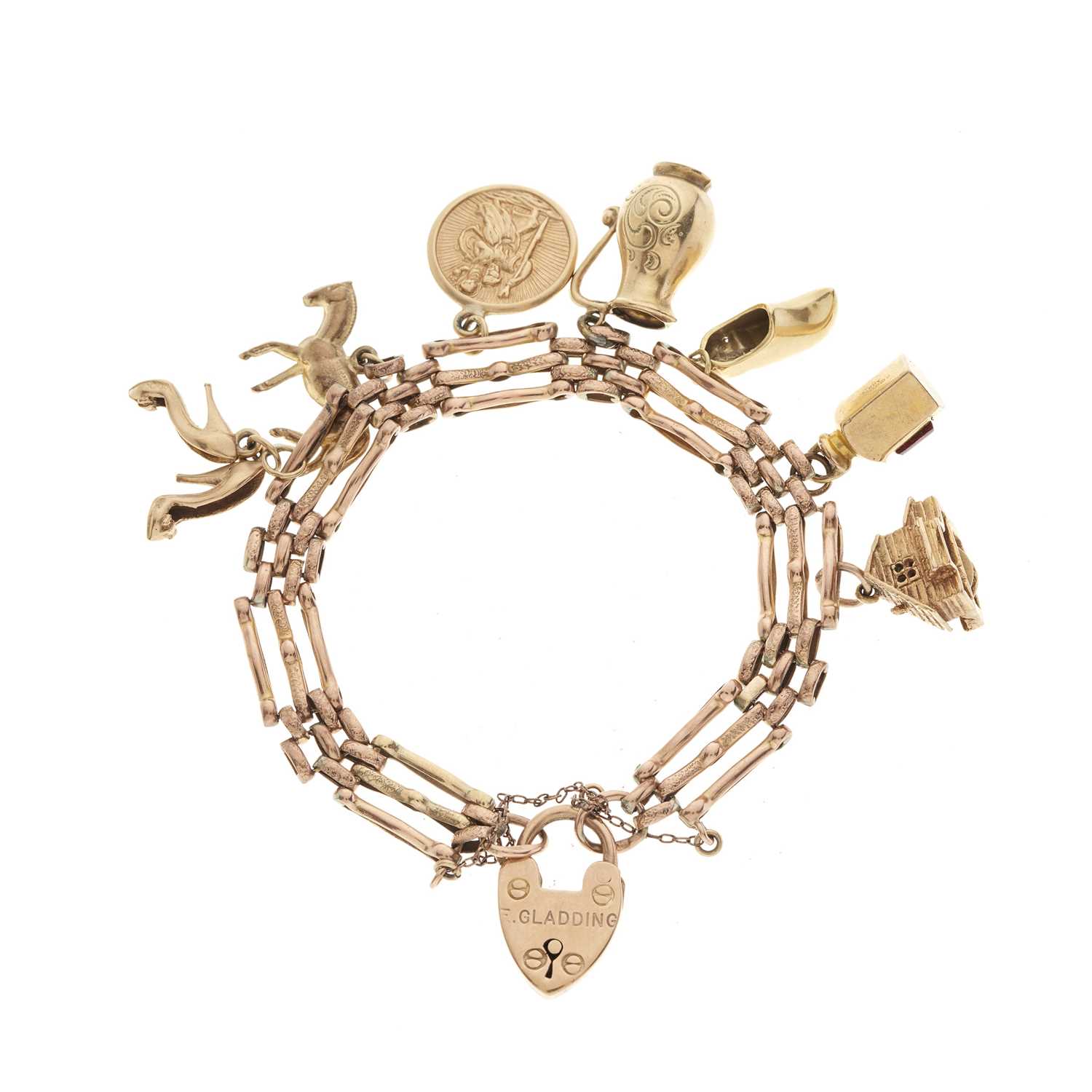 Lot 95 - A mid 20th century 9ct gold gate bracelet, suspending various charms