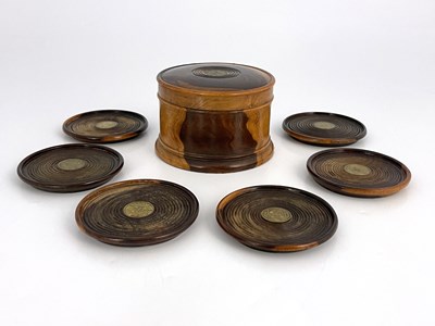 Lot 260 - A set of six lignum vitae turned coasters, in...