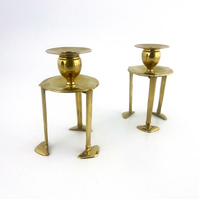 Lot 150 - A pair of Arts and Crafts brass candlesticks,...