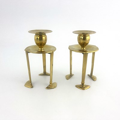 Lot 150 - A pair of Arts and Crafts brass candlesticks,...