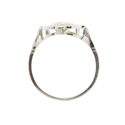 Lot 78 - A platinum peridot and diamond cluster dress ring