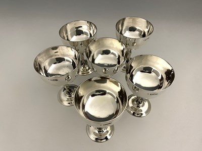Lot 26 - A set of six Edwardian silver wine cups, each...