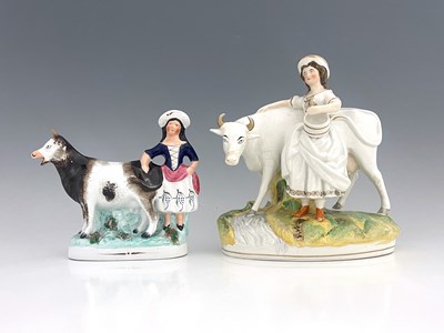 Lot 1035 - A Staffordshire cow and milkmaid figure, circa...