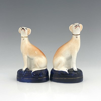 Lot 1043 - A pair of Staffordshire greyhounds, circa 1860,...