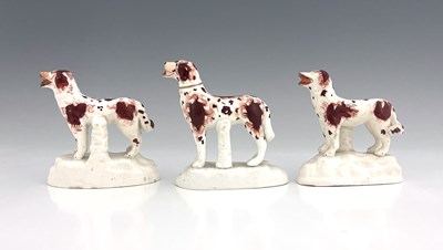 Lot 1014 - A group of Staffordshire dog figures, modelled...