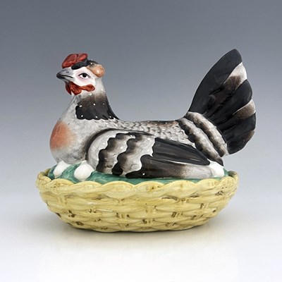 Lot 1040 - A Staffordshire pottery hen on nest, circa...