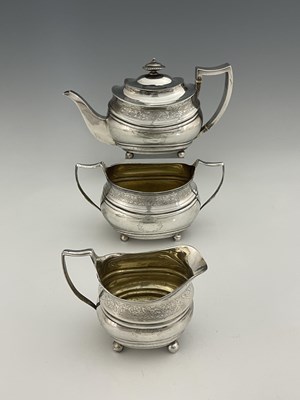 Lot 446 - A George III matched silver three-piece tea...