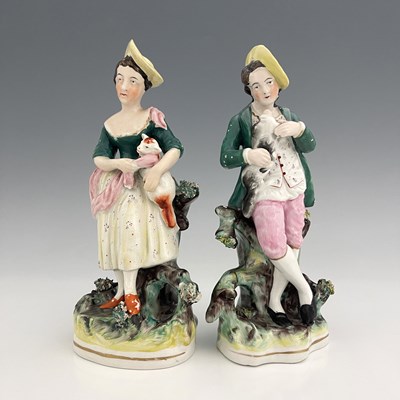 Lot 1031 - A pair of Staffordshire pastoral figures,...