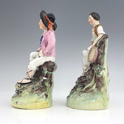 Lot 1063 - A Staffordshire figure pair of street...