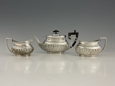 Lot 473 - A George V silver three piece tea set,...