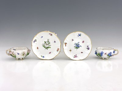 Lot 811 - Two Meissen florally encrusted tea cups and...