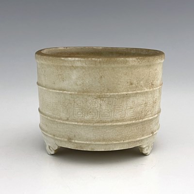 Lot 576 - A Chinese celadon glazed brush pot,...