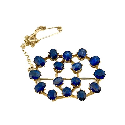 Lot 20 - A gold and sapphire brooch, two interlocking...
