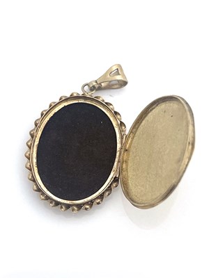 Lot 18 - A 9ct gold and ruby locket pendant, oval form,...