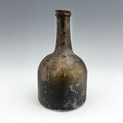 Lot 648 - An early 18th century glass wine bottle, squat...