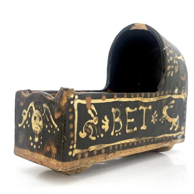 Lot 1006 - A Yorkshire slipware model cradle, 19th...