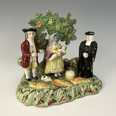 Lot 1046 - A Staffordshire 'Tythe Pig' figure group,...