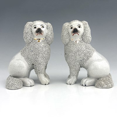 Lot 1045 - A Staffordshire matching pair of poodles,...